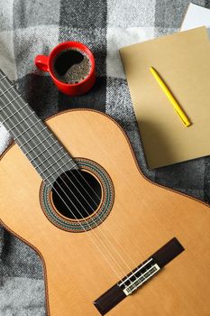 Music maker composition on checkered plaid, top view