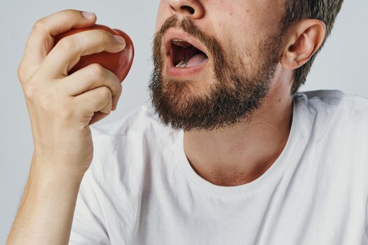 Bearded man in white t-shirt vegetables diet health vegetarian. High quality photo