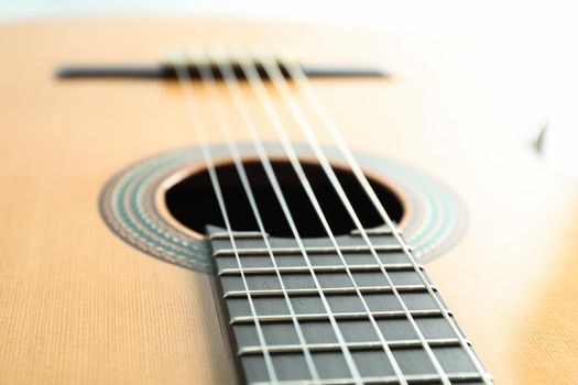 Beautiful six - string classic guitar on white background, closeup