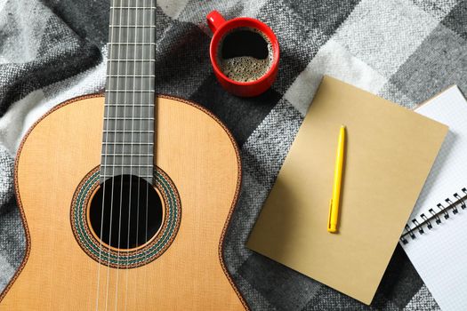 Music maker composition on checkered plaid, top view