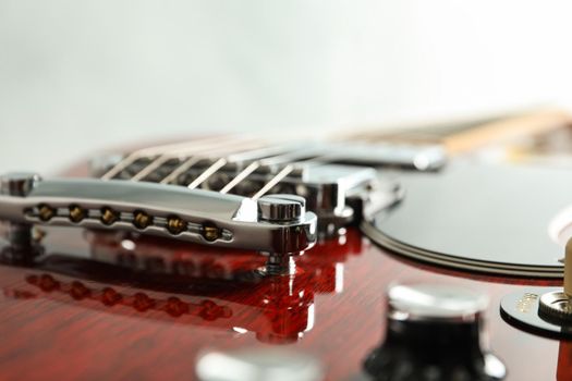 Beautiful six - string electric guitar on white background, closeup