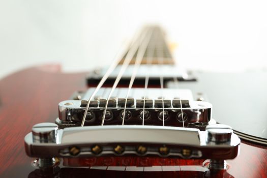 Beautiful six - string electric guitar on white background, closeup