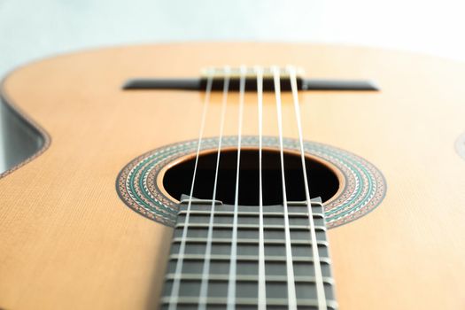 Beautiful six - string classic guitar on white background, closeup