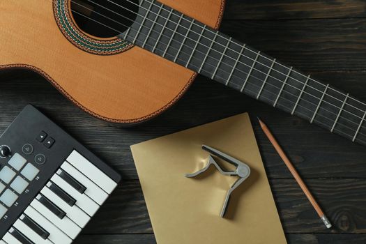 Music maker composition on wooden background, top view