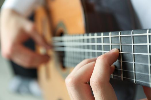 Man playing on classic guitar, space for text