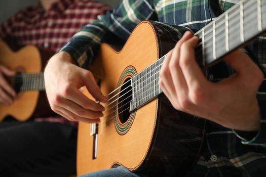 Two guitar players with classic guitars, space for text