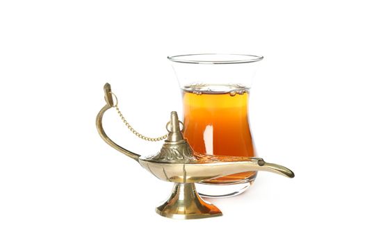 Glass of tea and Aladdin Lamp isolated on white background