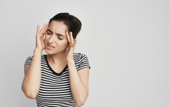 woman in t-shirt holding her head discontent health problem. High quality photo