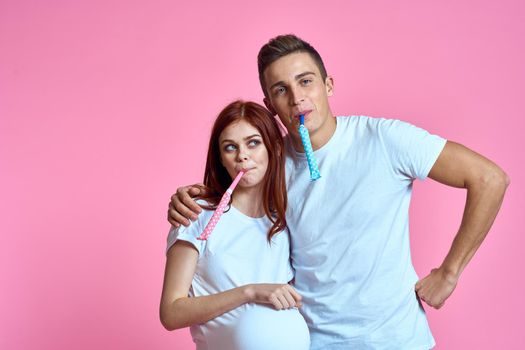 young couple family parents pink background hug. High quality photo