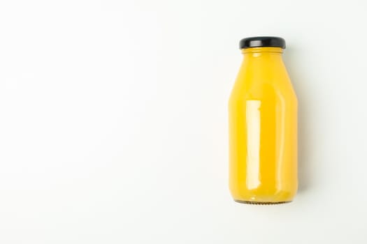 Fresh orange juice in bottle on white background, space for text. Fresh natural drink