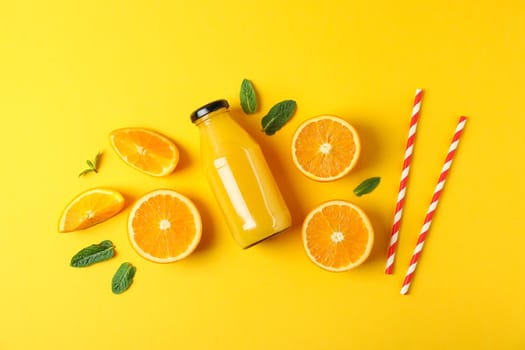 Flat lay composition with oranges, tubules and orange juice in bottle, space for text. Fresh natural drink