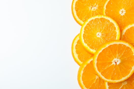 Composition with orange pieces on white background, space for text and closeup. Citrus fruits