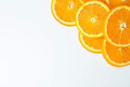 Composition with orange pieces on white background, space for text and closeup. Citrus fruits