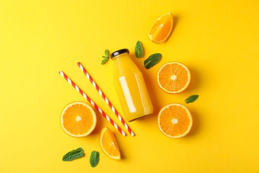 Flat lay composition with oranges, tubules and orange juice in bottle, space for text. Fresh natural drink