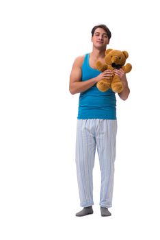 Young man in pajamas with toy animal isolated on white background