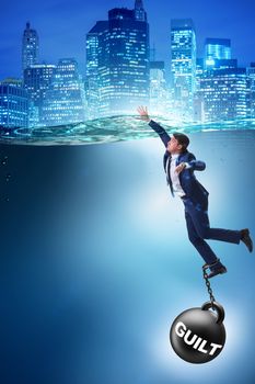Businessman drowning under the burden of sin and guilt