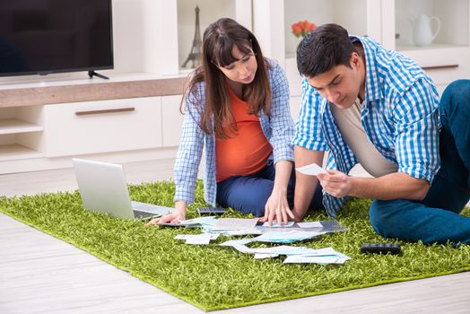 Young family in budget planning concept