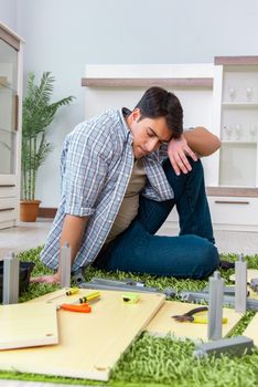Man assembling furniture at home