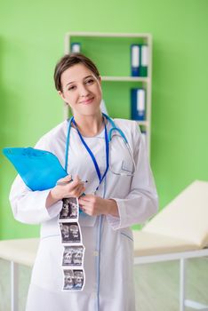 Female doctor gynecologyst writing medical record in the clinic