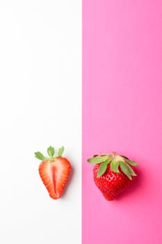 Strawberries on two color background, space for text. Summer sweet fruits and berries