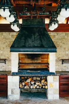 Large grill oven indoors, with wood to be melted under it