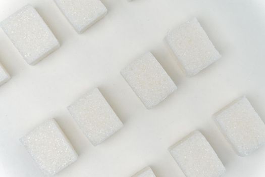 sugar cubes glucose ingredient calories energy light background. High quality photo