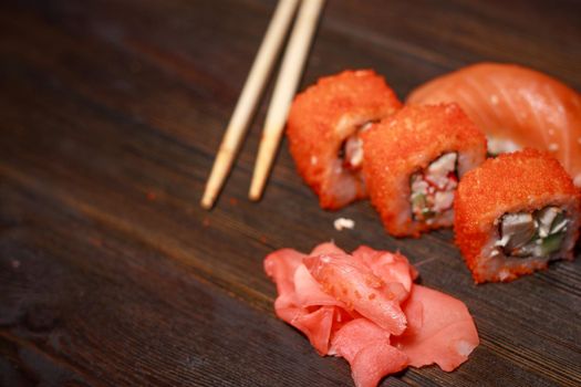 sushi rolls asian cuisine wooden table wasabi ginger. High quality photo