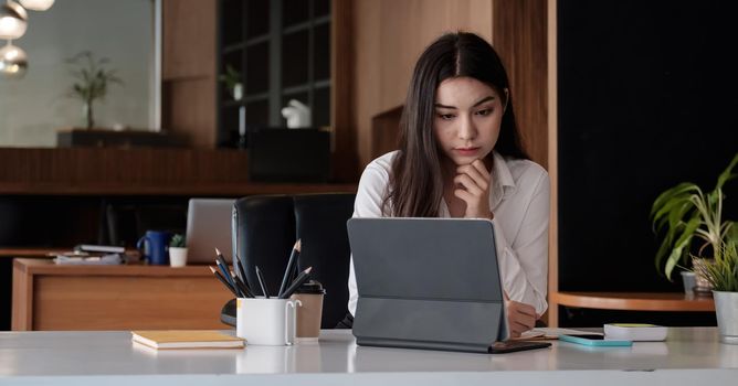 Shot of Business woman using laptop analysis with business data at her office