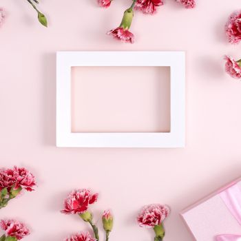Concept of Mother's day holiday greeting background design  with carnations bouquet on pink background