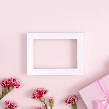 Concept of Mother's day holiday greeting background design  with carnations bouquet on pink background