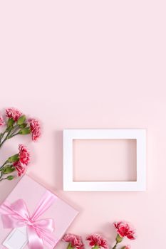 Concept of Mother's day holiday greeting background design  with carnations bouquet on pink background