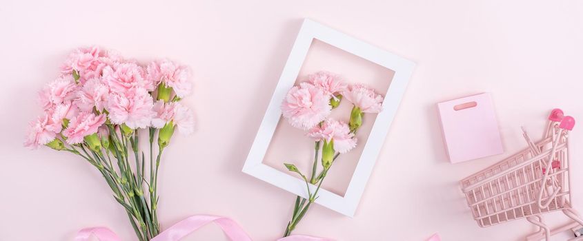 Concept of Mother's day holiday greeting design with carnation bouquet and gift on pink background