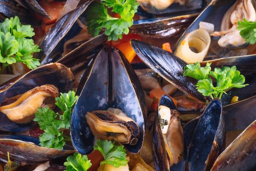 Boiled mussels in cooking dish with parsley on dark wooden background