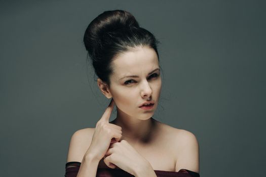 woman with bare shoulders gesturing with hands hairstyle and emotions model. High quality photo