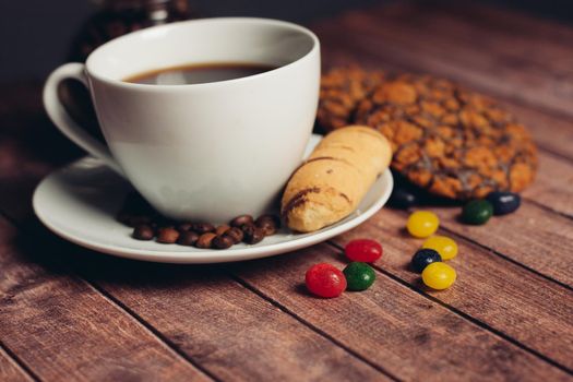 a cup of coffee cookies sweets wooden table snack. High quality photo