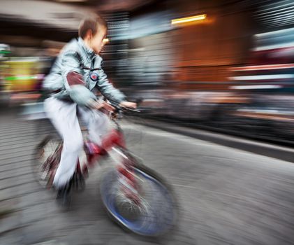 Abstract image of cyclist on the city roadway. Intentional motion blur