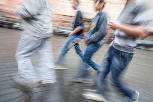 Group of young people hurrying about their business.  Intentional motion blur