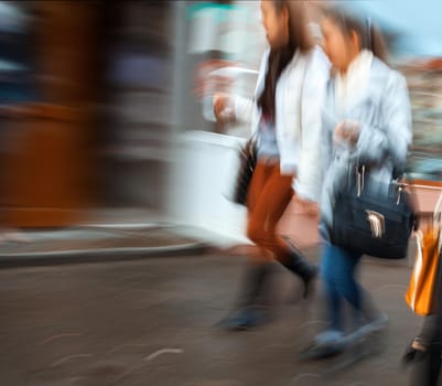 Group of young people hurrying about their business. Intentional motion blur