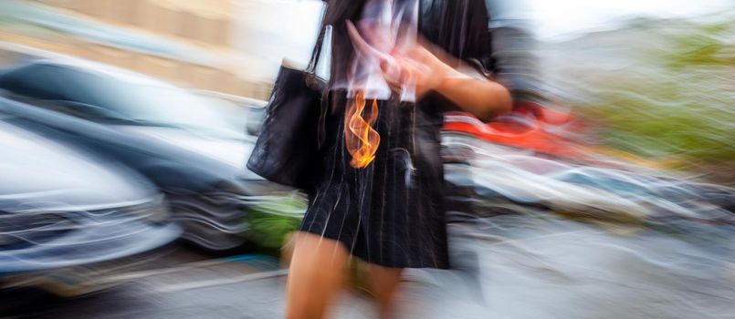 Abstract image of a woman walking down the street. Intentional motion blur