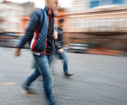 Group of young people hurrying about their business. Intentional motion blur