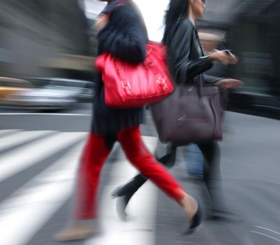 Young people at rush hour walking in the street. Intentional motion blur