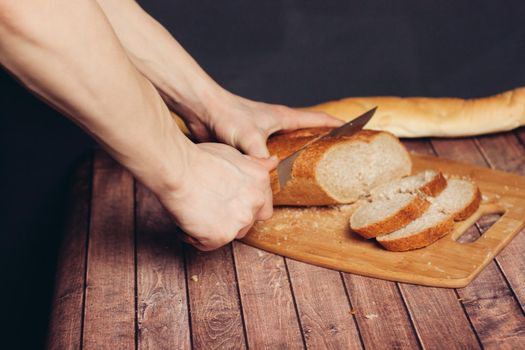 slicing a fresh loaf on a cutting board kitchen meal. High quality photo