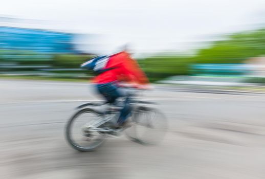 Abstract motion blur image of active people on bicycle in the city roadway