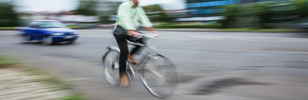 Abstract motion blur image of active people on bicycle in the city roadway