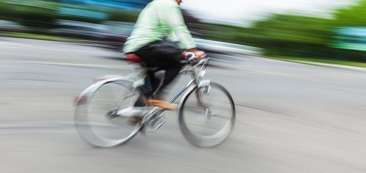 Abstract motion blur image of active people on bicycle in the city roadway