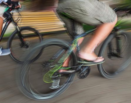 Abstract motion blur image of active people on bicycle in the city roadway