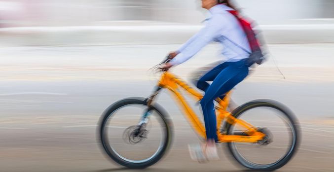 Abstract motion blur image of active people on bicycle in the city roadway