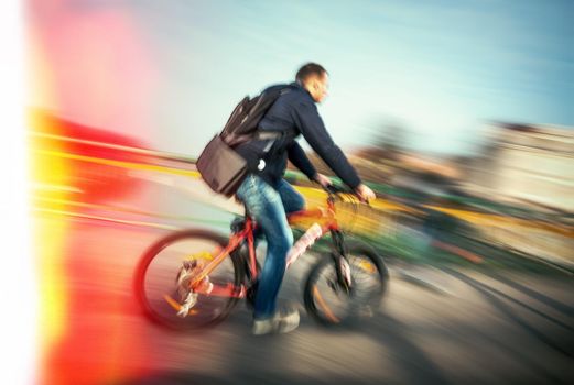 Cyclist on the city roadway in motion blur. Vintage filter with intentional color shift