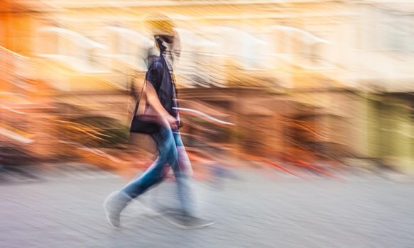 Soft focus blurred abstract image of young people in the street. Intentional motion blur