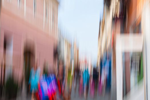 Urban city life background. Motion blur image of crowd of people walking on busy city street